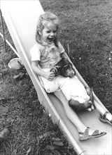 Girl and chimpanzee on the slide