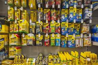 Various adhesives on shelves