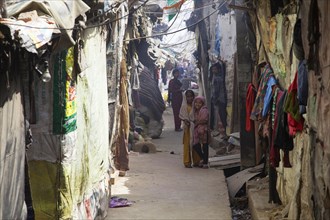 Children in the slum between dwellings at the Ghazipur garbage dump