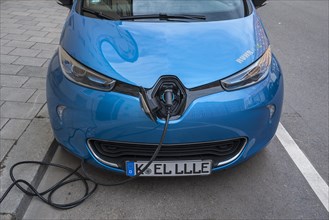 Electric car is charging charging cable