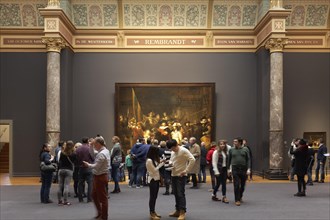 Museum visitors in front of the Nightwatch of Rembrandt
