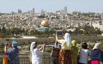 Women photograph the Dome of the Rock