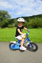 Girl rides on children's bike