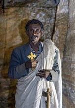 Orthodox priest inside the rock church Medhane Alem