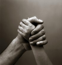 Child's and parents hands holding each other