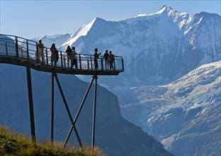 Tourists on the observation deck of the First Cliff Walk by Tissot in front of the Fiescherhorn north face and the Grindelwald glacier