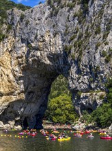 Canoes with canoeists on the Ardeche river near the arch of Vallon Pont d'Arc