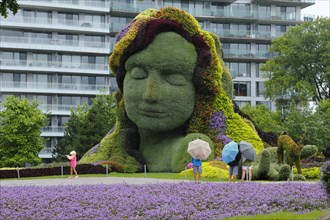 Plant sculpture Mother Earth with modern building behind