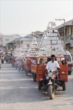 Procession carrying items for young men entering monkhood