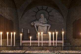 Pieta sculpture with candles