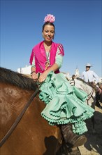 Horsewoman wearing a colourful gypsy dress