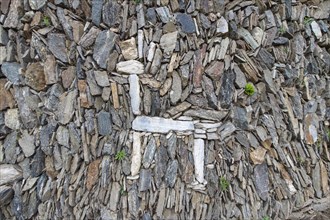 Llama figure in an old stone wall