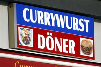 Sign Currywurst and Doner are sold in the same shop