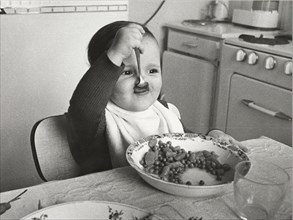 Toddler eats with spoon