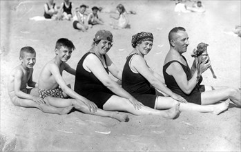 Family on the beach with dog ca. 1928