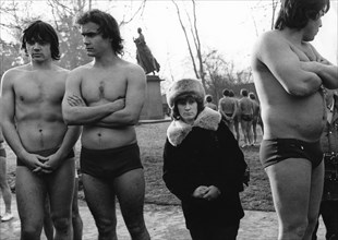 Three big men and a small woman ca. 1970s