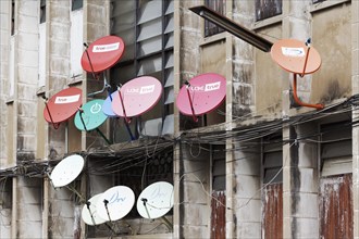 Colourful satellite dishes on a building
