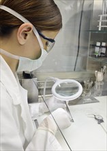 Pathologist examining a tumor in a hospital laboratory