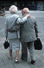 Old couple embraces