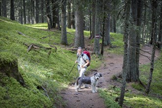 A hiker and his dog in the Rauris jungle