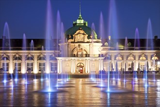 Illuminated imperial palace with water fountains in the blue hour