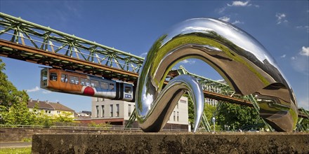Suspension railway and work of art I'm alive made of polished stainless steel