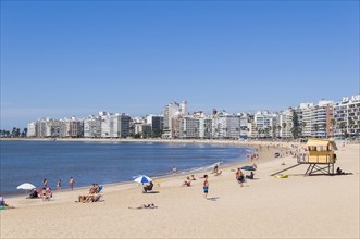 Swimmers at the city beach and skyscrapers in Montevideo