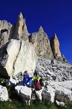 Hikers on the south side of the Three peaks of Lavaredo on the way from the Auronzo hut to the Bullele Joch hut