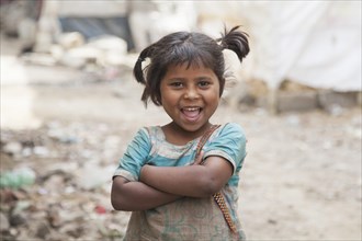 Happy little girl in the slum at the Ghazipur garbage dump