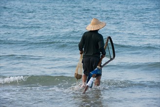 Fisherman wearing a straw hat