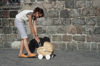 Wife and dog push doll pram