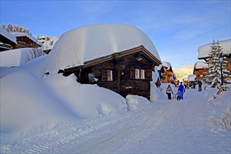 Village road with snow-covered chalets