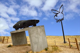 Playboy Bunny and sports car on a concrete base