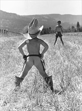 Two boys playing Cowboy
