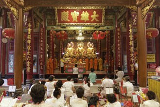 Prayer hall with Buddhist monks and believers