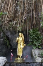 Buddha statue and artificial flamingos