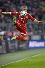 Soccer player Joshua Kimmich from FC Bayern Munich artistically on the ball