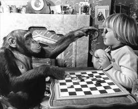 Girl and chimpanzee play the mill