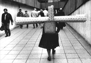 Woman carrying carpet about 1970s