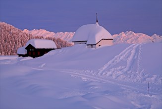 Maria zum Schnee chapel in the snow in the village centre at dusk
