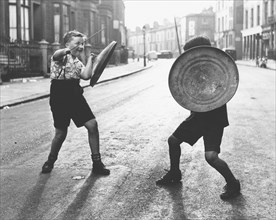 Children with shield and stick play knights