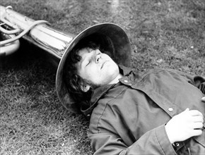 Man sleeps with his head in tuba
