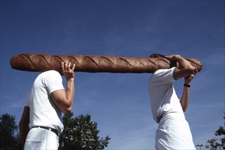 Men carry giant baguette