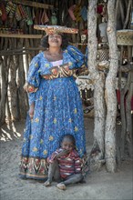 Native Herero woman with typical headgear and clothes and child