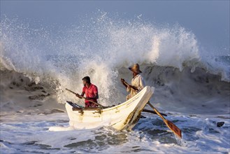 Fishermen in the boat in the surf