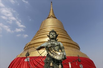 Bronze figure in front of the Golden Chedi on Phu Khao Thong
