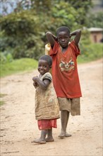Two African children on a sandy track