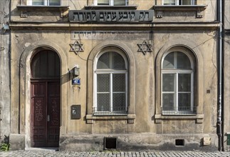 Remains of Torah inscription and stars of David on house facade in Kazimierz