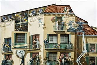 Painted house facade with film scenes