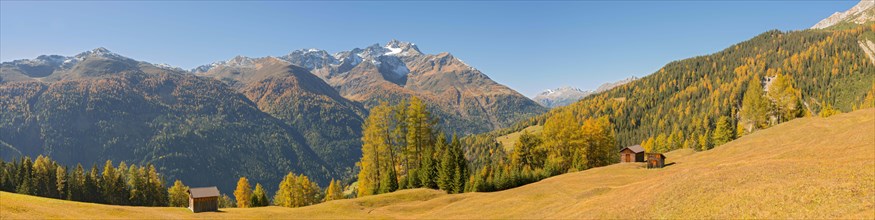 Autumnal mountain landscape with alpine huts
